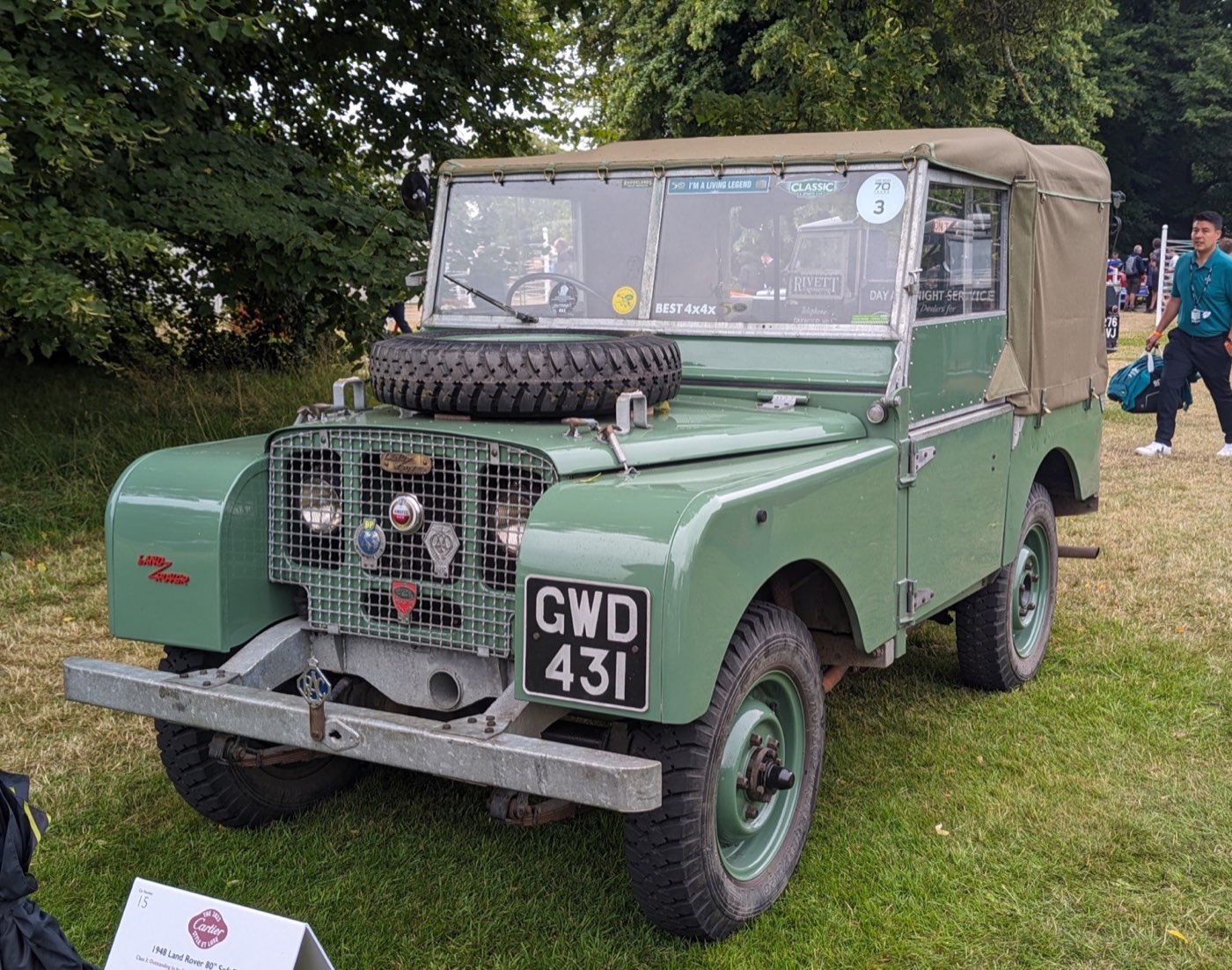 A 1948 Series I 80-inch soft top, GWD 431, at a 2023 show: the same year, wheelbase, canvas tilt and bonnet-mounted spare as LAND48, which carried its spare on the bonnet after an auxiliary tank took the wheel well.
